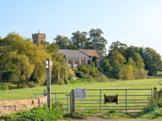 St Laurence Church with gate and style
